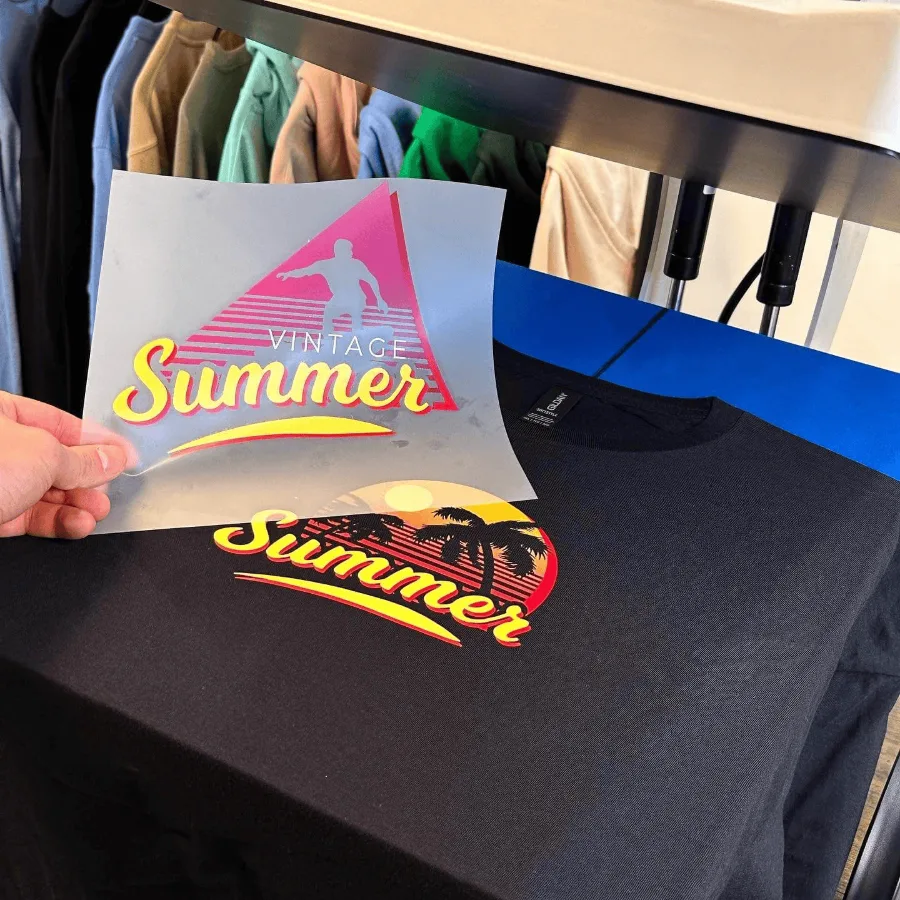 Custom DTF transfer being heat-pressed onto a black t-shirt